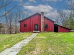 This property paints a truly serene picture of a nature-filled escape, with endless potential for both full-time living or a weekend retreat. The 87-acre wooded property offers the perfect balance of privacy and natural beauty, with a large pond, wildlife, and a trail for exploring. Bring your horses and with proper permitting, turn this into a possible animal sanctuary. Two dwellingsâ€” a primary residence and a rustic cabinâ€” ensure ample space for family and friends, each enjoying their own private retreat while being close to nature.The primary residence, a well-maintained contemporary-style home, provides comfortable living with its open concept layout, stone fireplace, and updated features like vinyl flooring. The large great room and full kitchen are ideal for family gatherings, and the deck adds an outdoor space to relax and enjoy the surroundings. If desired there are fully approved plans in place with the Town to expand or build a larger home, the options for growth are already set.The rustic cabin offers a charming spot down by the pond, with all the essentials like a full kitchen and bath, plus room to make it cozy for guests. It could easily be transformed into a peaceful getaway space with a fantastic view.The large two-story barn is another highlight, offering plenty of space for storage, recreation, or even an office and can also be used for a garage. The possibilities for this property seem endless.Located under two hours from NYC and close to charming towns, wineries, and year-round events at the Dutchess County Fairgrounds, this is an ideal location to escape the hustle and bustle while still being connected to local attractions.This property truly is a hidden gem, combining the best of country living with comfort and modern amenities, plus plenty of opportunities for customization and expansion.