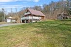 WOW! Where else are you going to find this type of property in the majestic Catskills for this price?! Unique & eclectic chalet/cape style home with 3 bedrooms, 2 1/2 bathrooms, a huge & usable walkout basement/lower level, a 600 square foot detached garage/workshop built in 2021, lots of decks, patios & balconies, a hot tub, AND a relaxation shed! NEW upgrades include main floor full bathroom (gorgeous!), kitchen appliances, washer/dryer, den, paint, molding and more! Just two owners -- original owners were a father and son that built this themselves, and their craftsmanship and overall quality shows! Primary floor features open floor plan, lots of windows and a slider leading to wraparound front deck/balcony (with a swinging bench), bedroom, den/office (with separate entrance), full bath. Upstairs feature two sizeable bedrooms (one with vaulted ceilings, walk-in closet and a balcony) and a full bathroom. Lower level/basement is 1, 000 square feet (included in total square footage listed here) with laundry and a bar area, as well as French doors leading out front. Three heating options -- electric, propane, or pellets. Great 2 acre lot includes mature plantings, a hot tub, outdoor fireplace, lots of deck space for entertaining, that workshop/garage with an attached 120 square foot lean-to space, and a cozy relaxation shed. Fabulous area minutes to the world-famous Bethel Woods Center for the Arts, site of the original 1969 Woodstock Music Festival! Also close to historic downtowns of Jeffersonville and Callicoon (both with lots to do!), and surrounded by dairy farms and horse farms. Perfect as a weekend getaway, an Airbnb, or year-round living! Turnkey, come and get it!