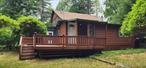 Rustic and spacious log-sided home, perfect for all seasons, located in the desirable Bethel area within the charming hamlet of Smallwood. This property offers access to Mountain Lake, including a beach area and options for boating, kayaking, fishing, and hiking in the local park. Enjoy community amenities such as tennis courts, a pool, and a clubhouse which is not not mandatory to join.This rare find features 4 bedrooms and 3 bathrooms, with a master bedroom and en-suite bath conveniently located on the first floor. The layout includes a country kitchen, dining area, and an oversized living room with an Avalon woodstove. Every room is equipped with individual baseboard heat controls for added comfort. Additional conveniences include a laundry room, ample closet space, and standout features such as two decks, a large screened-in porch, and a barbecue area. The property also boasts a 4-car driveway for easy parking.Ideal for year-round living, a vacation getaway, or an AirBnB investment. Furniture is optional and can be included. Situated on a quiet dead-end road, this home is close to Bethel Woods, White Lake, and other attractions and shopping destinations in Sullivan County.