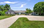 This is a rare opportunity to acquire a stunning property close to the ocean, brimming with potential. Whether you wish to embrace the charm of the existing home or create your ultimate dream sanctuary, this 1.65+/- acre estate offers nearly endless possibilities. Nestled in the highly desirable Quogue estate section, this property features a 4, 366+/- sq ft home with 5 bedrooms and 4 full baths. The expansive lot size and considerable square footage make it a fantastic place to relax or entertain. The well-designed interior spaces are light-filled and full of character. The living room boasts a wood-burning fireplace, cathedral ceiling, two cozy built-in book nooks, and French doors leading to the patio. An adjoining sitting room with built-in bookcases and window seats is perfect for reading or playing games. The original part of the home includes an open kitchen with breakfast bar, an en suite junior primary bedroom, two guest bedrooms, and a bath. A new wing added in 1998 offers a second kitchen, primary suite with spa bath and dressing room, spacious family room, additional guest bedroom, bath, and a screened porch for al fresco dining. The second floor features a loft area ideal for guests. 19 Quaquanantuck Lane is a private, serene setting with ample room for a pool, pool house, and tennis court. All this, within a half-mile to the Quogue shops, market, and the village dock that hosts amazing sunsets. Plus, moments from Dune Road and some of the most breathtaking ocean beaches in the world. This property is a unique opportunity to own a piece of paradise in one of the most sought-after locations within the Quogue estate section.