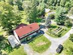 Attention old house buffs, home office professionals, organic garden hobbyists, & extended families. Total finished sq ftge is 4800 not including finished basement in the house. It is worthwhile to see this circa 1800&rsquo;s carriage house home sits on over 3 acres of privacy and has many original details. The interior features 4 bedrooms, an original stone fireplace in one of the bedrooms, an open concept on the lower level with a great kitchen, wide planked floors, wood burning stove in the living room, original (200 yrs apprx) wood beamed ceilings, mostly newer windows, large master bedroom with high ceilings, a marble bathroom, fantastic walk out basement which has a full bathroom, family room which is used as a studio for family. The wooden deck is huge with ample shade and space to enjoy outdoors and there is an additional deck with a hot tub. As a major bonus, the property includes an impressive 60â€™ x 30â€™ two-story outbuilding. The lower level boasts high ceilings, garage access, and space for hobbies or work, while the upper level features a light-filled art studio/office with a full kitchen, bathroom, and panoramic views of the grounds. This gorgeous property is a nature lovers dream with many specimen plantings, fruit trees, annual flowers, a greenhouse, an organic garden with a beehive, a bird haven, amazing vegetables and beautifully set up for the next homeowner. This property has a chicken coop, a pond, and lots of play space. LOW TAXES! Make this your new home!