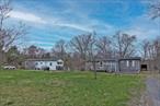 Looking for a piece of property for a great low price? Looking for two homes for the price of one? Here is a great opportunity for you to acquire one manufactured home, and one mobile home, both on the same plot of land with 2.30 acres! Investors will consider this property for rental income. Those interested in home ownership will consider this property as well, given you can live in one of the homes and rent the other. At a low list price for either option the income should significantly reduce or even cover the mortgage cost! The main manufactured home has 3 bedrooms and 2 bathrooms, while the mobile home has 3 bedrooms, 1 bath. The value for these homes comes due to their need for renovation, if you are handy, you can gradually fix up each home gradually. Also, with the land being 2.30 acres, you are in a great position to have additional options as you can build a new home if desired. There&rsquo;s many possibilities here, with a great value in price!
