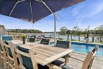 Welcome to 81 and 83 Beach Rd in the Hamlet of Aquebogue. 81 Beach Road (Parcel ID 0600-113-00-02-00-016-002) This meticulously maintained waterfront property is the perfect blend of luxury, comfort and lifestyle. For the boating enthusiast, there are deep-water docks in your back yard on Meetinghouse Creek that connects to Peconic Bay and additional space for your watersport crafts. The backyard oasis has a stunning in-ground salt-water heated pool (concrete wall/vinyl lined), surrounded by beautiful bluestone patio, a luxurious outdoor spa like mahogany shower and a fully equipped outdoor grilling kitchen with Blaze marine grade storage cabinets, slate countertop, beverage refrigerator and a sink with hot/cold water. There is ample room for dining and seating, creating a welcoming living area for you and your visitors and the perfect place to watch the breathtaking sunsets. The house is 1920 square feet of beauty and perfection featuring three bedrooms and three full elegant bathrooms. All three bathrooms have been renovated. The primary en-suite on the upper floor boasts a private balcony overlooking the water. The bright and airy open concept main floor displays a chefâ€™s kitchen with quartz countertops, high-end stainless-steel appliances, a Viking Range, the dining area, the living area complete with a wood burning fireplace and hardwood oak floors throughout all designed for relaxation and effortless entertaining. The 1-car attached garage offers options for additional storage. There is a Level 2 EV Charger. Custom Cedar Fencing.Conveniently located to farm stands, several golf courses, wineries and breweries, acclaimed restaurants and all the North Fork has to offer. This is more than a home-it&rsquo;s a lifestyle! Taxes for #81: $14, 44183 Beach Rd (Parcel ID 0600-113-00-02-00-016-001). The listing price includes a second house located in front of #81, street facing. It is a continuous separate lot.The enchanting, renovated cottage, just shy of 1000 square feet, filled with charm has a comfortable living room, dining room, kitchen, a nice sized bedroom and a full bathroom along with a washer and dryer and outside patio area. All of this and a water view. The cottage has heat and A/C and is a perfect private retreat for guests or lucrative rental potential. The community, known as Hoccabauk Park, has private beach access just for the community. There is NO HOA fee. There are farm stands and restaurants nearby which all add to the charm of this area. Taxes for #83: $5, 030