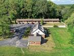 Prime Hospitality Investment Opportunity on Mirror Lake - 10-Unit Motel & 2-Family Home Located on the banks of Mirror Lake, this 1.2-acre hospitality-zoned property offers a unique investment opportunity just 5 minutes from Downtown Kingston&rsquo;s waterfront and 90 miles from NYC. Formerly operating as the Lake Motel, the property consists of two adjacent parcels: a 10-unit motel and a renovated 2-family home, providing excellent potential for short- or long-term rentals. The motel building features 10 studio units with kitchenettes, 8 of which have been completely renovated with modern finishes, including subway tile baths and updated flooring. The remaining 2 units are occupied by long-term tenants. Each unit has separate 100-amp electric service, and an 11-meter electrical panel allows for future utility separation if desired. Additional amenities include wall-mounted heating & cooling units, a complete water treatment system, and well/septic infrastructure. The building also includes a dedicated laundry room with 2 washers and 2 dryers, providing added convenience for tenants or guests. The 2-family home, originally the motel office and owner&rsquo;s quarters, has been converted into two fully renovated rental units. The first-floor unit is a spacious 2+ bedroom with new natural gas forced air heat and electric hot water. The second-floor unit is a bright 1-bedroom apartment with electric heat and hot water. Each tenant pays for their own utilities. With 200 feet of private lake frontage, this property is well-suited for hospitality use, offering boating, fishing, and winter activities such as ice fishing and skating. The private lake has no public access, ensuring a peaceful and exclusive setting. Whether continued as long-term rentals or repositioned as a boutique lakeside motel or Airbnb destination, this versatile investment presents a strong income-generating opportunity in the Hudson Valley.
