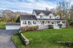 Gracious Home with Stunning Water Views in Prime Mattituck Location! Perched on a hill directly across from Breakwater Beach, this elegant home offers breathtaking views of the Long Island Sound from nearly every room. Set on over 1.5 acres of meticulously manicured grounds, the property includes a private tennis court, making it an ideal retreat for both relaxation and recreation. Enjoy coastal living at its finest from the expansive porch overlooking the waterâ€”perfect for entertaining or unwinding. Inside, hardwood floors run throughout, complementing a spacious living room with a cozy wood-burning stove. The large primary bedroom features an ensuite bath and generous closet space. Additional features include an attached two-car attached garage and a separate three-car detached garage. The home also offers flexible living options, with separate guest suite with private access. Located in the heart of Mattituck, this exceptional property places you minutes from all the North Fork has to offerâ€” wineries, beaches, boating (3 minutes to boat ramp) and charming village shops.