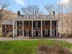 Nestled on over 5 acres, and backed up against Harriman State Park, this 5, 500+ sf Georgian Colonial blends turn-of-the-century craftsmanship with enduring elegance. This unique combination of size, acreage, privacy, and location is an opportunity rarely offered in this region. A stunning brick facade, twin chimneys, and formal entryway welcome you with understated grandeur. 9â€™ ceilings and oversized windows fill every room with natural light. Thoughtful moldings, original hardwood floors, and custom millwork are found throughout, telling the story of a home built with integrity and care. The formal living and dining rooms feature fireplaces and are perfect for intimate entertaining and large gatherings.The chefâ€™s kitchen, thoughtfully updated for modern living, retains its charm with inset cabinetry, and a butlerâ€™s pantry that speaks to the home&rsquo;s original design. The sunroom overlooking the garden provides a relaxing space to unwind.Upstairs, five spacious bedrooms each include en-suite bathrooms, and the third floor boasts large additional living space, ideal for a home office, studio, or 2 additional bedrooms.Outside, manicured formal gardens, brick patio, and original stone walls complete the picture â€” Sit and listen to the stream running over the rocks in this serene private oasis. This property is a hikerâ€™s and nature loverâ€™s dream location. The charming stone cottage is a perfect spot for guests, or for rental. Only 30 minutes from the GWB, and in the heart of the Hudson Valley. Come and make this beautiful home your own.