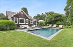 Darling Cottage in East Hampton.  This cape-styled cottage (2000 SF +/-) is exceptionally convenient located on a tree-lined street with sidewalk escorting you into the Village center. Very well-maintained, there is a lovely living room with wood-burning fireplace, marble counters and stainless-steel appliances in the eat-in kitchen, and an office/yoga nook. The dining room and enclosed media porch with built-in bar face the enclosed, private backyard. A total of four bedrooms (2 bedrooms on each floor) and 2 full bathrooms. The saltwater Gunite pool is surrounded by a bluestone patio ready for all of your al fresco dining. An outdoor shower, lush landscaping, generator, and central air are some of the modern amenities. Located one block from train and two blocks from everything else makes this home convenient to all the Village offers including shops, restaurants, transportation and ocean beaches.