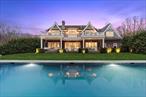 Tucked away down a winding driveway, past a gated entrance, and set on 6.5 acres of serene privacy, this extraordinary gabled estate offers the perfect Hamptons retreat. Conveniently located near the attractions of Bridgehampton and Sag Harbor, this immaculate residence spans over 8, 000 square feet of pristine living space, featuring custom interior design and high-end details on all three levels. The home includes 8 spacious bedrooms, 7 full bathrooms, 2 half baths, a three-bay garage, a large gunite pool with a spa, and an expansive bluestone patio with multiple lounging areas, all surrounded by mature trees, lush landscaping and exterior lighting. A dramatic, double-height entry foyer welcomes you into the home, leading to the open living area with a fireplace and sliding windows that seamlessly blend the indoors with the natural surroundings. A luxurious den with a second fireplace provides an elegant retreat, offering serene pool views. The oversized chef&rsquo;s kitchen is a dream, perfect for cooking, dining, or entertaining. Carrara marble accents the generous island with bar seating, keeping guests close while you cook. Premium Sub-Zero, Wolf, and Miele appliances, including two dishwashers, make this space a chef&rsquo;s paradise. The formal dining room, just beyond, offers ample space for seating 12 or more guests. The main level also features one of the two primary bedrooms and a stylish powder room. Upstairs, you&rsquo;ll find 5 ensuite bedrooms, including the grand primary suite, which boasts a balcony, walk-in closet, and an expansive spa-inspired bathroom with marble sinks, a soaking tub and top-tier fixtures. Two of the guest suites also feature balconies, offering sunset views over the trees. The upstairs is completed with a large laundry room. The fully finished lower level offers 10-foot ceilings and is flooded with natural light from deep window wells. It includes two guest suites, a recreational area, media room, half bath, and a professional-grade home gym. The serene grounds are beautifully designed for entertaining and easy living, with lovely outdoor dining areas, and a heated 50-foot gunite pool with an integrated spa, all surrounded by natural bluestone. There&rsquo;s a covered porch for lounging and ample space for sunbathing, with the pool receiving beautiful southwestern light until sunset. The attached 3-car garage features high-performance epoxy flooring and custom cabinetry for toys and accessories. The home is equipped with Control4 automation, an indoor/outdoor sound system, security system, water filtration, and a multi-zone HVAC with humidification. This combination of meticulously maintained classic luxury, complete privacy, and easy access makes this estate one of the most exceptional properties available today.