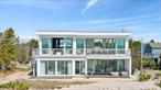 TURNKEY OCEANFRONT JEWELSited on top of the dunes in Westhampton Beach, this custom-renovated oceanfront property offers the ultimate beach house experience. The ground floor has 2 beautifully appointed bedrooms, both with ensuite baths, as well as a third beach-facing bathroom. An adjoining living room creates flexible common living space and opens out to a covered deck overlooking the dunes. The breathtaking second floor has 10 foot ceilings, a wraparound terrace, and a wall of sliding glass doors that allow expansive ocean views and endless sea breezes. The sleek kitchen has a breakfast bar, stainless Scandinavian appliances, and a pass through window to the western deck. This exceptional property lives as though it were twice its size, and with its unique indoor/outdoor design, its the ideal getaway for beach lovers! Available July $45k, August $55k.