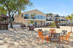 Rare one of a kind luxurious waterfront legal two-family home in Bayville with expansive private beach! Tucked away at the end of a serene cul-de-sac on the Long Island Sound, this extraordinary two-family, 5-bedroom, 2-bath waterfront home offers a rare opportunity in the highly sought-after Bayville beach community. With just over 105 feet of privately owned beachfront, largest in the area, this property is a rare and perfect oasis for tranquil, beachside living, only 45 min from Manhattan, bring the Hamptons to Nassau! The main floor, with entertainers open floor plan boasts a beautifully designed gourmet eat-in kitchen with substantial island, vaulted ceilings, skylights, radiant heated floors and balcony to enjoy a morning cup of coffee overlooking your private beach. The adjacent dining area opens into a sun-filled living room with breathtaking panoramic views of the long Island Sound through the wall of windows and complemented by soaring ceilings which flood the space with natural light. This level also includes three spacious bedrooms and a modern full bath, creating the ideal layout for comfort and luxury, The lower level, which can function as a separate living space, offers two additional bedrooms, a fully updated eat-in kitchen with radiant floors, and a cozy living room complete with a fireplace and sliders that open to a covered patio. Step directly onto your own private beach from this floor, ideal for relaxed waterfront living. With several decks perfect for outdoor dining and entertaining, this home provides an unparalleled setting to enjoy magnificent sunsets over the water. This waterfront gem in Bayville offers an exceptional combination of luxury, privacy, and natural beauty with direct beach access for unparalleled waterfront living. Additional information: Appearance: Excellent+