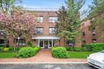 Prime Location!!! Move right in to this beautifully maintained, second floor unit near town & LIRR.This spacious corner apartment offers a versatile entry foyer that doubles as a home office. The expansive living and dining area is flooded with natural light. The renovated eat-in kitchen features granite countertops, stainless steel appliances and the convenience of an in-unit washer and dryer. Additional highlights are hardwood floors, crown moldings, and two window A/C units. Enjoy the perks of a newly renovated lobby, an on-site gym and laundry room. Convenient resident parking around the circle (with permit). Ideally located close to shopping, parks, public buses and the LIRR. Cats allowed!