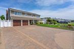 Do not miss out on private beach access (with low annual fees of $50) together with rear water views of the Bay and Lido Beach Golf Course. This beautifully maintained and updated 4 bedroom, 3 full bath home is located in the desirous Lido Dunes Community! This amazing home welcomes you with a spacious foyer and an open floor plan, high/vaulted ceilings, radiant heating in all 3 bathrooms, hardwood and tile floors, crown molding, and French doors. The second floor boasts 4 oversized bedrooms and 2 full baths. The Primary bedroom has vaulted ceilings, double doors for ensuite access featuring stall shower and stand alone tub and bidet, and double vanity. The primary bedroom, open sunlit second floor landing and second bedroom all have double sliders leading to a large upper rear trek deck with water views overlooking the Bay and Lido Beach Golf Course. Backyard with mature privacy trees, showcases a large outdoor lighted grill/grilling area, lighted gazebo and patio area perfect for outdoor entertaining. Bonus feature is an outdoor hot AND cold shower to rinse off after a day at the beach that leads to indoor laundry/mudroom!This beautiful home has updated garage doors and elegant double entry doors with a two car garage and private driveway parking for six.Don&rsquo;t miss out on this rare opportunity to live by the beach with style and space.
