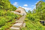 Perched on a hillside with water views, this beautifully renovated 3-bedroom, 3-bathroom raised ranch offers the perfect blend of privacy, space, and convenience. Set on 10 acres, this home is surrounded by nature, yet just minutes from restaurants, shopping, I-864, I-84, and the Southeast train stationâ€”making it an ideal escape without sacrificing accessibility.Step inside to find a sun-filled open layout with modern finishes throughout. The spacious living and dining areas flow seamlessly onto multiple outdoor patios and a large deckâ€”perfect for entertaining or simply enjoying the tranquil surroundings. The updated kitchen features sleek appliances, great storage, and ample countertop spaceDownstairs, a finished walk-out level offers a game room, a large workshop, a full bathroom, and direct access to the attached one-car garage and oversized patio. Ideal for hobbyists, guests, or multi-generational living. With three full bathrooms and well-sized bedrooms, including a primary suite with its own private bath, comfort and functionality are at the forefront.Whether youâ€™re enjoying morning coffee with a view, hosting friends for a barbecue, or unwinding in the game room after a day outdoors, this home offers something for everyone.Listing agent is seller.