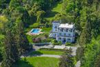 Step into a world of timeless elegance with this beautifully restored Historic Victorian-Era Estate built in 1869 designed by renowned architect Charles Homer Davis. Grandiose and gracefully set atop two pristine acres in the Incorporated Village of Lloyd Harbor, this stately home offers a commanding presence with sweeping views of nature and tranquility. Boasting Queen Anne-style flourishes, including sweeping gables and a tower with wrap around porch that hints at the home&rsquo;s artistic legacy. The expansive layout is filled with warmth yet boasts over 6500 sqft of living space over 3 floors. Sunlight streams through oversized windows highlighting exquisite birch and walnut inlaid hardwood floors, intricate hand-carved moldings with a rich, welcoming color palette. The soaring 10 ft ceilings and open floor plan create an inviting sense of space which is perfect for both intimate gatherings and grand entertaining. Chef&rsquo;s eat in kitchen provides a modern display of craftsmanship with marble & soapstone counters, Sub Zero refrigerator, Wolf gas oven range, radiant heated floors with direct access to back staircase and breakfast nook off the deck. Carefully updated with thoughtful enhancements, this home features beautifully appointed baths with radiant heated floors, natural gas heating, central air, and a Kohler gas generator giving comfort in every season. Outdoor living is just as inviting with multiple access to wrap-around porch which beckon for morning coffee or quiet evenings; while the large in-ground pool offers endless Summer enjoyment, with new liner, steps, and heater in 2024/25. The spacious detached 2 car garage adjoins former horse paddocks which presents endless possibilities. Irrigation system allows for a meticulously maintained property with gardens and mature specimen trees. Perfectly positioned near the vibrant town of Huntington, you&rsquo;re just minutes from charming restaurants, boutique shops, cultural events, and nightlife. Nature enthusiasts will appreciate nearby hiking trails, scenic parks, and preserved lands, while beach lovers can escape to Long Islandâ€™s breathtaking shores in no time. As a resident of Lloyd Harbor, youâ€™ll also enjoy access to the private beach only 1.7 miles away including tennis facilities, moorings, and summer camp, and only 3 miles to Caumsett State Park. An unparalleled lifestyle in one of the North Shoreâ€™s most coveted communities. Taxes: $29, 261/yr. Property is on the National Historic Registry.