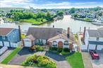 Live the dream on this rare 80-foot-wide waterfront property! A true boaterâ€™s paradise! Located on a deep, wide canal, this expanded 4 bedroom, 2 bath expanded ranch offers breathtaking, unobstructed water views from nearly every angle of its sprawling 2, 842 square feet of contemporary living space. Step inside to an open concept layout featuring a spacious eat-in kitchen and sunlit family room, beautifully anchored by a dramatic floor-to-vaulted-ceiling 3-sided stone fireplace. Sliders lead to a generous deck with a pool, perfect for entertaining against the stunning waterfront backdrop. Wake up every day to glorious main-level water views from your master suite, complete with private deck access. Enjoy the spa-like bathroom that includes an amazingly large soaking tub and separate shower. Outdoors, the 80-foot frontage truly shines with boat slips and a massive floating dock. The current owner houses 2 - 22ft boats, a 40 ft boat and a few jet skis...bring your super sized boat! Additional highlights include a heated garage, manicured landscaping, circular driveway, and more. Don&rsquo;t miss this rare opportunity to own 80 feet of pristine waterfront living, an exceptional lifestyle for boaters, entertainers, and anyone who appreciates panoramic views and luxury comfort. PS The pool is now OPEN!