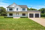 Welcome to a brand-new, meticulously crafted home in the heart of Hampton Bays. This spacious 4-bedroom, 2-full and one-half bathroom residence offers the perfect blend of modern elegance, comfort and style. Sited in a prime location, on a private drive, south of Montauk Highway near all the desired amenities. The open floor plan with spacious living areas feature plenty of natural light and hardwood floors throughout. A chef-inspired eat-in kitchen is fully equipped with stainless steel appliances, center island, and sleek quartz countertops. The delightful mahogany front porch, 2-car garage and full basement with egress complete this brand-new offering. Ready for summer 2025 occupancy.