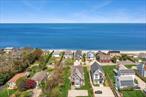 *Unique North Fork Haven in Jamesport by the Sound*Tucked away in one of the most picturesque corners of the North Fork, this Nantucket-inspired gem has everything you need for a serene summer getaway. Just 0.2 miles (about 3 minutes- no car needed) from Iron Pier Beach and a short drive to the best of the North Forkâ€”renowned vineyards, charming farm stands, local shops, scenic trails, and fantastic dining.This home features 10 ft. ceilings and high-end finishes throughout, with stunning views day and night.*The First Floor*Enter through a foyer with a dramatic 20-ft ceiling into a breathtaking Great Room designed for gathering, featuring a wall of windows and sliders opening to a huge covered terrace overlooking the Long Island Sound.Thereâ€™s space for everyone around a large dining table, plus cozy seating with a big-screen TV, a booming Sonos sound system, and a gourmet kitchen with a huge island. Cook with Thermador appliances (gas range, double ovens, fridge), microwave, toaster oven, air fryer, coffee bar, large pantry, and all the cookware you need to bring your culinary vision to life.A sun-filled, fully equipped home office with a TV overlooks the front yardâ€”a perfect space to get work done. A full bath rounds out the floor plan.*The Upper Floor*Up the grand staircase from the foyer are 3 bedrooms and 2 full baths, each with their own unique feel:The Sound View Primary Suite features a king bed, walk-in closet, TV, and a marble ensuite with a double vanity, shower, and jacuzzi tub overlooking the Sound. Sliding doors open to a private balcony.The Sunrise Room has a vaulted, beamed ceiling, queen bed, closet, TV, and lots of light.The Surf Room includes a bunk bed (twin above, queen below), dresser, and bright morning light.The guest rooms share a full bath and a linen closet keeps extras organized.*The Finished Basement*A recreation space you need to see to believe, with a brand new ping pong table, a laundry room with Samsung W/D, plus a lounge area with sofa, recliner, dry bar, high-top table, theater quality 85 TV, and Sonos, complete with a powder room. Sliding doors open to a patio with a grill and a fully stocked shed with beach gear.*3 Levels of Outdoor Living*Firstly, there&rsquo;s a lush backyard patio with loungers, Adirondack chairs, a fire feature, and a grillâ€”perfect for unwinding, picnics, or fireside evenings.Secondly, a spacious, covered terrace just off the Great Room has comfortable lounge seating and sweeping water viewsâ€”ideal for your morning coffee or evening glass of wine.Lastly, a large private balcony off of the primary bedroom has 2 comfy chairs and a small table. The views of the sunsets, the Sound and the night sky are unforgettable.Plus, enjoy the convenience of an outdoor showerâ€”perfect for rinsing off after a day at the beach.*Fully Stocked Shed*Stock the beach-cart with whatever the day requires: chairs, umbrellas, boogie boards, pool noodles, Kadima racquet set, Giant Badminton, sand toys, beach towels, Turkish towels, water shoes. Also: 2 adult bikes, 1 kidâ€™s bike, helmets, Cornhole, and a (safe!) axe-throwing game.*Other Amenities*Blazing fast 300 mbps fiber-optic internetâ€”so everyone can stream, Zoom, or game with ease. There&rsquo;s central air, abundant linens and pillows, plenty of storage, and thoughtful touches throughout.Enjoy music via Bluetooth on the Sonos sound system in the Great Room, basement, and terrace simultaneously. Serene neighborhood, with ample parking in the front of the home. About 90 mins from NYC. Close to Mattituck, Riverhead, Southold, and Greenport/Orient ferries.*Summary*This beautifully crafted home is designed to, and filled with everything you&rsquo;ll need to help you relax, recharge, and reconnect. From beach days, to exploring the North Fork, to nights out and cozy nights in, a stay here is as comfortable and effortless as it is unforgettable.