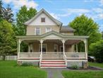 Step back in time with this beautifully preserved 1900 colonial, offering 4 bedrooms, 2 full baths, and 2, 150 sq ft of timeless charm. Stunning natural woodwork, handcrafted details, and gorgeous period features fill the spacious living areas, including a large living room, formal dining room, and an eat-in kitchen complete with an original dumbwaiter and Butlerâ€™s staircase. Upstairs, the primary suite boasts a walk-in closet, accompanied by three additional generously sized bedrooms. A walk-up attic with beautiful stained glass windows provides even more space and character. Modern updates include newer windows and a 50-year roof installed approximately 2 years ago. Set on over 1 acre of level, partially fenced property, this home also includes a detached one-car garage and ample driveway parking. A true blend of historic elegance and modern convenience â€” don&rsquo;t miss the opportunity to own this rare gem!
