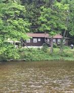 Escape to your own Adirondack retreat on 2.73 acres with 400 feet of serene Bouquet River frontage. Fully renovated in 2021, this cozy cabin features knotty pine interiors and rustic charm throughout. Currently a successful Airbnb with a strong rental history, itâ€™s perfect as a vacation home, year-round residence, or income propertyâ€”with potential to add a second bedroom. Transferable flood insurance included. Sale consists of two parcels: #56.3-1-2.300 (2.37 acres) and #56.3-1-3.000 (0.36 acres). A rare opportunity for tranquility, income, and expansion potential in the Adirondacks.