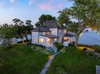 A one-of-a-kind offering, this property provides sweeping views of Long Island Sound and the allure of your own island. The expansive half-acre property, shaded by mature trees, also features its own boat dock and two boats for exploration of nearby waters and islands. Meticulously landscaped grounds with beautiful perennial gardens provide a picturesque setting for outdoor events. A beautiful stone pathway leads to a gazebo equipped with a fireplace, ideal for outdoor dining, cocktail parties, or quiet reading sessions. For water sports enthusiasts, the property provides a kayak and paddle board rack along with a launch area. The residence boasts a wide wrap-around porch offering unmatched views and a lower deck designed for relaxation. The living room, serving as the centerpiece of the home, showcases panoramic views of the Sound and is centered around an exquisite stone fireplace. Opening onto the covered porch, residents are encouraged to enjoy the coastal scenery both indoors and out. The dining room also offers impressive water views, while the spacious eat-in kitchen is outfitted with granite countertops, Subzero and Wolf appliances, and features views of the garden and harbor. The primary bedroom offers stunning views of Long Island Sound, complemented by two additional double bedrooms with water views, and another double bedroom offering delightful views of the harbor. The third floor provides flexibility to accommodate two more bedrooms or personalized spaces. An office with harbor views completes this welcoming home. Marrying quintessential coastal New England living with convenient proximity to NYC, this property offers a once-in-a-lifetime opportunity for a discerning buyer.
