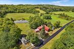 Nestled in a peaceful rural setting, this inviting gentlemanâ€™s farm offers over 3 acres of land, complete with a tranquil pond, multiple dwellings, and an array of outbuildings. This exceptional property offers a perfect blend of rustic charm, functionality, and versatility and is perfect for those looking to embrace country living with room to grow a home-based business. The heart of the property is a warm and welcoming 3-bedroom farmhouse, full of rustic character and practical charm. The spacious layout includes a country kitchen, cozy living spaces, and generous bedrooms, making it ideal for family living or hosting guests. A separate 2-bedroom cottage offers additional living quartersâ€”perfect for multi-generational living, rental income, or guest accommodations. Entrepreneurs, tradespeople, and creatives will appreciate the agricultural zoning which permits home businessesâ€”a rare and valuable feature. The detached garage with an attached workshop is well-suited for a mechanic, woodworker, or hobbyist, while the large barn offers ample space for equipment, storage and recreation. The carriage house provides covered parking for two more vehicles, with ample space for more storage above. Whether youâ€™re looking to run a small-scale agricultural operation, work from home, or simply enjoy the quiet beauty of the countryside, this versatile property delivers. With room to roam, a peaceful pond, and infrastructure already in place, itâ€™s the perfect balance of lifestyle and opportunity.