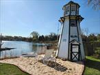Waterfront House with Private Beach area, Light House, boat ramp, deep water boat docks, Set up as 3 bedroom, 3 bathroom, 2 car garage, new kitchen with new applicances, 3 new bathrooms, new flooring on fist floor, double sided fireplace.