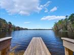 Amazing opportunity to experience lakefront living in Beautiful Sullivan County NY! Located on Highland Lake, a stunning natural crystal clear lake of approx. 250 acres. This spectacular place lends itself well for all water sports! Motorboating, skiing, fishing, canoeing, kayaking and swimming are all possible on this gorgeous lake! Hang a hammock and relax,  enjoy morning coffee on your own private dock or eat breakfast alfresco under your covered porch. This charming eclectic home has it&rsquo;s own artistic flare with wood carvings, beamed wood ceiling, built ins and beautiful rustic touches throughout. Large living area with lake views and craftsman stone and wood fireplace, large dining area with lake views, Galley kitchen leading to large laundry/utility room, 2 bedrooms and another bonus room to use as you&rsquo;d like, attached 2 car garage, covered deck and private lakefront dock complete this gorgeous lakefront picture. Explore the area when your not spending time at your lake house and enjoy the amenities, farmers markets, antique shops, hiking trails, Bethel Woods for music venues, Sullivan County Resort World Catskills and Katrite water park. Eagle watch or simply tube down the Delaware River! Only 2 hrs. NYC and Priced to sell so schedule your appointment to see this charming spot today!