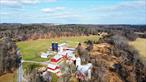Experience quiet country living with this beautiful 69 acre mixed-use farm & investment property! *For additional info on rental units, etc. please see MLS# 850195 (residential income)* -- This unique property has so much to offer, including FOUR rental units (3 single family homes + a 3-bedroom apartment), a scenic creek that runs along the entire edge of the property (perfect for summer swims!) , stunning woodland trails with views of the mountains and farmland, along with multiple large barns & fertile soils, ideal for farming & agriculture. ---- The 2, 157 sq. ft. historic stone house, built in 1780, has 2 bedrooms, 1.5 baths, hardwood floors, a large parlor, a dining room and living room, a porch overlooking the pond & a separate large carriage house 2 storage bays, a garage space, & a second floor that can be converted into additional storage or living space. This home has been recently updated & has a new roof & new septic system. ---On this property you will also find a large private pond (perfect for fishing!), tons of storage areas, and a 3-bay workshop (perfect for wood-working or other hands-on projects), several large barns capable of storing farm equipment, hay, boats, animals, lumber, vehicles, etc., and wooded areas for hiking & other ideal spots for hunting or camping. ---In addition to the stone house, this property also has 3 ADDITIONAL units. It also has a well and septic already set up for a potential 5th unit near the pond, making this an incredible investment opportunity! The fields can also be leased out to farmers for additional income & tax exemptions. ---The 3 additional units include: --The Log House which is a 1, 068 sq. ft. single-family log home built in 2005, with 2 bedrooms (plus 2 garrett rooms on second floor), 1 bathroom, a full basement and a large wrap-around porch. --The Ranch which is a 1, 425 sq. ft. ranch-style modular home built in 2005, with 3 beds and 2 baths, a large full walk-out basement, a beautiful spacious yard with a large pond, and a storage shed. There is also a small creek that runs along the back of the home, a large wrap-around porch, and a ton of privacy! -- *This unit is located on the opposite side of the road, along with the existing well & septic for potential 5th unit - this portion of the property would be easily subdividable.* ---The Milkhouse Apartment is a roughly 950 sq. ft. 3 bed, 1 bath apartment located on a second floor above the milkhouse. It has a spacious living room with a sliding door to the rear deck which allows for privacy and views of the back fields & the creek, and it also has a large storage unit underneath. ---The property also has 2 chicken coops if you are looking to raise your own chickens! There are also multiple large barns capable of housing many other animals, making this an ideal place for an animal sanctuary. ---This property offers both convenience & peace and quiet. It is located on a quiet back road, but less than 10 minutes from downtown Hudson, grocery stores, schools, restaurants, clothing stores, and the train station. Located in town of Greenport (does not have zoning). The possibilities here are endless -- come see it for yourself!