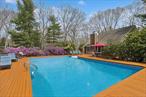 Your Private Summer Escape in East HamptonTucked away behind a gated entrance on 1.4 acres in the historic Northwest Woods of East Hampton, this impeccably renovated 4-bedroom, 3-bath home offers the ultimate in privacy, comfort, and timeless elegance. Thoughtfully updated throughout, the home features soaring vaulted ceilings, gleaming hardwood floors, and an architecturally striking layout that fills the space with natural light from sunrise to sunset.The heart of the home is the beautifully renovated chefâ€™s kitchen, which flows seamlessly into an open-concept living and dining areaâ€”ideal for entertaining or relaxing after a day at the beach. Enjoy central air conditioning, baseboard heating, 200-amp electrical service, and custom upgrades throughout for a true turn-key experience.Step outside to your very own private retreatâ€”an oversized mahogany patio, newly lined heated pool, and lush landscaping create a serene oasis just minutes from East Hamptonâ€™s famed village, Sammyâ€™s Beach, Cedar Point Park, wineries, boating, and more.Whether you&rsquo;re looking for a quiet luxury getaway or a high-performing investment, this home checks every box. With a proven Airbnb rental history and strong rent roll, it offers both personal enjoyment and income potential. Taxes are $10, 510 - WOWDonâ€™t miss this opportunity to experience the very best of the Hamptons lifestyle.