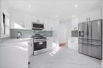 Large families will appreciate 221-09 131st Avenue! A meticulously renovated expansive cape sitting on a beautiful tree lined street of Laurelton! Sitting on a 40x100 lot featuring a wide private driveway, tons of yard space, this turn key move in ready single family property is the perfect house for buyers looking for space.Open the door and you are greeted by a welcoming foyer, equipped with a coat closet. The expansive sun drenched formal living area provides great space for entertaining. The formal dining area overlooks the beautiful granite kitchen any chef will love. Kitchen features floor to ceiling custom cabinetry, adorned with a full fleet of stainless steel appliances, and leads out into lush rear yard. Two spacious bedrooms on first floor as well as a fully tiled bathroom that boast state of the art wall & floor tiles. Up a flight of stairs onto the 2nd floor Two additional spacious bedrooms and a full bath awaits you. One rare to find feature of this property is its unique basement. The high ceiling full finished basement is equipped with both interior and exterior access and features 2 additional spacious bedrooms, a full bath and a summer kitchen. This charming single family has been fully re-imagined by an expert team of contractors featuring select wide oak wood flooring, recessed lighting, Central HVAC, brand new electrical, heating and plumbing systems throughout. 221-09 131 Avenue is conveniently located with close proximity to major transportation which makes commuting a breeze. Just off Francids Lewis Blvd, Springfield blvd, Merrick blvd. Short blocks to Cross Island Parkway, Belt Parkway, JFK Airport, restaurants, cafes, shopping centers, schools, parks and many other vibrant neighborhood amenities.