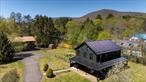 Experience the epitome of country living with this historic farm home nestled in the heart of the Catskill Mountains. Whether youâ€™re looking for your forever home, a weekend escape, or to start an Airbnb, this spacious home has it all! With nearly 2000 sqft of living space, this charming abode features a BRAND NEW METAL ROOF and GUTTERS, ALL NEW WINDOWS, 5 bedrooms and 3 full bathrooms, each thoughtfully updated over the years while still maintaining its rustic character with original hardwood floors and overhead wood beams. The sunny open-concept kitchen offers a delightful mountain view with sprawling meadow beneath. Glass French doors lead to a picturesque wrap-around porch while an additional door leads out to an expanded deck overlooking a large yard adorned with fruit trees, ideal for hosting BBQs or cozy evenings around the firepit! The first floor is complete with a full bath, bedroom, and family room. Ascend upstairs to discover 4 additional private bedrooms and 2 full baths, including one with a charming clawfoot tub and the other with a stand-in shower. The finished attic provides versatility as a play space, reading nook, artistâ€™s studio or whatever your imagination desires. Additionally, the newly renovated cedar barn offers nearly another 2000 square feet of usable space. On the first floor you have the convenience of a 2 car garage, full bath, and finished space with radiant heat throughout the entire first floor. Make your way upstairs to a versatile entertainment area complete with bar and French doors leading out to a brand new deck with breathtaking mountain views. Walk out your front door, and you can enjoy the convenience of being a few steps away from Willow Trailhead/Mt.Tremper fire tower, one of the most famous Catskill hiking trails, or hop in your car and drive a short 7 miles to historic downtown Woodstock, or the adorable town of Phoenicia, while still being close to skiing, wineries, spas, shopping and top rated restaurants. Come and see this spectacular home for yourself. Your country retreat awaits!