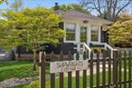 Welcome to the Shipwright&rsquo;s Cottage in East Quogue, a place where timeless charm meets effortless modern living. This two-bedroom, one-bath retreat was originally built in 1932, offering an intimate yet airy atmosphere for those who seek more than just a homeâ€”those who seek sanctuary. Tucked south of the highway in one of the area&rsquo;s most peaceful, bike-friendly enclaves, the location offers rare access to a quieter rhythm of Hamptons life. Picture your mornings unfolding with a serene stroll into the heart of East Quogue, a town that pulses with character all year long. Local shops, beloved restaurants, farm stands, and a full calendar of community happenings keep the energy alive while preserving a small-town soul. Venture inside and feel the warmth. The open layout invites movement and ease, where neutral palettes, rich wood floors, and curated finishes create a sense of calm. Oversized, elegantly framed windows fill the space with natural light and frame lush garden views in every direction. Each room is designed to reflect not only beauty but intentionality. Beyond the threshold, the magic continues. The private, fenced yard offers both security and serenityâ€”perfect for pets, gatherings, or quiet reflection. A detached garage sits ready to evolve into your creative studio or become the kind of party barn that brings your vision to life. For those called to the soil, a spacious garden shed with a potting area and raised vegetable beds await your touch. Set among streets steeped in heritage, the property enjoys seamless access to train lines and 27 East, keeping you connected while helping you sidestep the seasonal rush. Water lovers will appreciate the close proximity to two established marinas and the East Quogue marine park, making days on the bay feel effortless. As the neighborhood grows with signature projects like the Hampton Shipyard restoration and The Hills Luxury Golf Course, this home becomes more than a place to live. It becomes part of a story unfoldingâ€”a story of possibility, peace, and lasting value.This isnâ€™t just a home. Itâ€™s an invitation to a life well-lived.