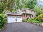 Be the 2nd owner in 60 years of this cherished family home. Recently renovated 4 Bedroom/3 Bath Colonial on 1/2 acre plus landscaped property. Minutes to Beach, Pool, Dining & sunsets. Although the house enjoys proximity to the water, its elevated position ensures it is safely out of any flood zone.Cozy sunken family room with fireplace, spacious living room overlooking gardens. Fabulous 2 tier deck overlooking wooded backyard. Lower Level media room also with lots of storage. Attached 2 car garage. Gleaming wood floors, new windows, CAC, updated roof and freshly painted inside and out!