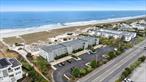 Welcome to the Ocean Dunes - an exclusive, highly sought-after condominium complex featuring only 20 oceanfront residences, and one of just three complexes on Dune Road open year-round, affording you unlimited access to the Hamptons 365 days a year. This is your opportunity to own a coveted first-floor waterfront unit with direct beach access, offering panoramic, unobstructed views of the Atlantic. Managed by HCMC, the East End&rsquo;s leading property management company, the Ocean Dunes offers its residents an on-site staff member along with concierge services during the summer season. Ideally located just 1.4 miles from the newly revitalized Main Street and moments over the Jessups Lane bridge, this sunlit condo blends oceanside serenity with village convenience. Step out onto your private deck - mere steps from the sand - and experience the Hamptons in every season. Inside, the thoughtfully designed layout features two bedrooms, including an en-suite with a walk-in shower and Toto toilet. A spacious powder room is already plumbed for a future full bath, and in-unit laundry adds everyday convenience. The eat-in-kitchen boasts custom Wood Mode cabinetry with under-cabinet lighting, a barn-style sink, granite countertops and backsplash, and premium appliances including a panel-ready Jenn-Air refrigerator, GE range and microwave. Enjoy meals in the dining area and unwind in the open living room, both of which flow effortlessly to the expansive ocean-facing deck - the ideal setting for sunrises, ocean breezes, and summer entertaining. Additional highlights include solid wood interior doors, three new ductless AC/Heating units (installed just 3 years ago), and hardwood floors throughout. Ocean Dunes also provides a residents-only laundry facility with brand new washers and dryers, and dedicated storage. With very few units ever coming to market, this is a rare chance to own in one of Westhampton Beachâ€™s most desirable waterfront enclaves. Donâ€™t miss the opportunity to make this exceptional coastal retreat your own.