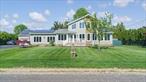 SIGNIFICANT PRICE REDUCTION AND TREMENDOUS VALUE!! Field of Dreams!!! Come and enjoy a true North Fork experience at your very own doorstep in Aquebogue! Sit on your front porch watching seeded fields yield sweet corn at harvest time, while inhaling the crisp, salt air from the nearby Peconic Bay. You will experience Peace and Privacy down this less-traveled lane, which only a few neighbors enjoy, including a small boutique farm stand, as well as a farm field stretching from Boulevard to Bay!This home not only showcases a front porch Farm view, but also features a large living room, boasting large picture windows providing wonderful, scenic views, as well as a wood stove, ideal for warming the home on those chilly, winter evenings! The eat-in kitchen is light and bright, featuring granite countertops and attractive tile backsplash. Off the kitchen there is a laundry/mud room with an adjacent half-bath and outside entrance leading to the spacious patio. There are two bedrooms on the first level, as well as an additional guest suite. The entire second floor comprises an oversized Primary ensuite, displaying endless farm-field views from its three, spanning picture windows. The large, two-car detached garage also offers additional space, which may be used for an office, recreation room or with proper permits, a potential rental space. The room also houses a mini-split unit, providing both heat and A/C. The Full basement offers plenty of opportunity to finish as well. The backyard is both private and spacious, featuring a large patio, which is ideal for entertaining friends and family alike. There is also plenty of room for a pool, if so desired. The house is equipped with fully-owned Solar Panels, ensuring low energy bills for years to come! Make this home your new, â€œHome, Sweet, Home, â€ and enjoy the world-class Restaurants, Shops, Beaches, Vineyards, Farm stands, Breweries, Art Galleries and Entertainment venues so prevalent and renowned on the North Fork of Long Island. Now is your golden opportunity, must see!