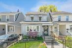 Discover this amazing Colonial-style two-family home nestled in the heart of Saint Albans, offering 1, 550 sq ft of well-utilized space and abundant natural light. The first-floor unit features a spacious one-bedroom layout with a full bathroom, an eat-in kitchen, a cozy living room, and a sun-filled enclosed porch-style front room. Upstairs, the second unit includes two bedrooms, a full bathroom, an eat-in kitchen, and a fully finished atticâ€”perfect for extra living space or storage. The finished basement offers a half bath, washer and dryer, and a private side entrance, ideal for added convenience or potential rental use. Enjoy outdoor living with a patio beside a rare oversized one-car garage (13x20) featuring a unique second-floor lodge. The property sits on a generous 31x100 lot with a private three-car driveway. Located close to all major amenities and transportation, this versatile property is perfect for homeowners and investors alike.