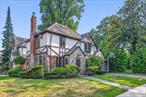 Welcome to 8702 Chevy Chase Street, a fully renovated Tudor-style gem in the heart of Jamaica Estates. This 4-bedroom, 3-bathroom home sits on a 5, 640 sq ft corner lotâ€” including a sizable and private, landscaped backyard.Inside, the main level offers a blend of open-concept and traditional layout. High ceilings, rich wood floors, abundant natural light from Andersen windows, and an accented fireplace create a warm, airy, and family functional living space.The kitchen is truly the heart of the home, thoughtfully designed with heated floors, custom cabinetry, quartz countertops, a skylight, and premium appliances â€” including a built-in cooktop and double oven. Sliding glass doors lead directly to the backyard, making indoor-outdoor living and entertaining effortless.Upstairs, youâ€™ll find three bright and comfortable bedrooms, including a sunlit primary suite with a private balcony and ample closet space. The spa-inspired main bathroom features heated floors, vaulted ceilings, a skylight, a walk-in shower, and a luxurious soaking tub.The top level includes a private fourth bedroom with custom built-ins â€” a flexible space perfect for guests, a home office, or a cozy lounge.The fully finished basement expands your living options, complete with a private separate entrance, abundant storage, laundry area, and versatile space for a home gym, media room, or extended guest suite.Outside, the private backyard has space to garden, grill, shoot hoops, or simply relax under the open sky.Set in one of Queens&rsquo; most sought-after neighborhoods, Jamaica Estates is known for its peaceful, tree-lined streets, strong sense of community, and close proximity to top-rated schools, shopping, parks, and public transit. This home is 10 minutes walking distance from Union Turnpike retail corridor and the F train on Hillside avenue.