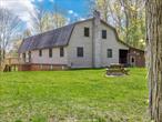 Historic barn styling and colorful contemporary style create a wholly unique vibe at 3639 Atwood Road. The 4 BD, 2 BA&rsquo;s distinctive gambrel outline pays homage to the Hudson Valley region&rsquo;s agrarian history and harmonizes perfectly with its serene 6.3-acre wooded setting. But inside, you&rsquo;ll find a take on country living that&rsquo;s FRESH! The showstopping great room features 22-foot ceilings adorned with exquisite tongue-and-groove cedar and magnificent sapele beamsâ€”a rare African hardwood prized for its rich, distinctive character. A wall of windows is accented by stained-glass transoms which are particularly visible from the second-story landing. Natural light streams into the open concept living and dining areas creating an ever-changing canvas of Hudson Valley beauty across the seasons. When it&rsquo;s cool, an efficient pellet stove fills the soaring space with warmth. The home&rsquo;s position on the acreage is private while its position on the map, in the midst of some of the most charming small Upstate towns (Stone Ridge, Rosendale, High Falls, Marbletown, and Accord), the Catskill Mountains, the Ashokan Reservoir, and the Shawangunk Mountains means that life here can be full of friends, fun, culture and outdoor adventures. The gourmet kitchen pairs timeless granite countertops with solid hickory cabinetry, complemented by two expansive pantries that offer exceptional storage for the culinary enthusiast. Upstairs, a luxurious 650-square-foot primary suite features dual walk-in closets, a freshly updated full bath, and additional storage spaces. Outdoor living is equally elevated here with a newly constructed deck, a covered porch, and a private enclosed hot tub. In keeping with the contemporary design, the property&rsquo;s exceptional infrastructure includes a whole-house generator ensuring uninterrupted power, a comprehensive security system, and what many consider the crown jewel: an oversized heated garage designed to accommodate a pickup truck with plow plus two additional vehiclesâ€”this sort of storage/workspace (with heat!) is a true rarity in mountain properties. Come home to sophisticated contemporary living in a beautiful Upstate setting!