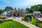 Presenting an unrivaled 14.6-acre waterfront estate known as MiddleSea, recently transformed by a meticulous multimillion-dollar renovation with unparalleled luxury. Showcasing spectacular panoramic views, this exceptional property features approx. 2, 000 feet of Sandy Beach, ensuring complete privacy. This world-class estate has 3 distinct homes: (The Main House, The Beach House and the Guest House. All multi-million dollar residences on their own. At the heart of the estate lies a 20, 000 square-foot red-brick mansion. The main house features, 30 ft ceiling entry foyer with a timeless black and white marble floor and wrought iron white marble wrap around staircase, five ensuite bedrooms, including a lavish primary suite with dual luxury baths and a private balcony that overlooks breathtaking water views. The elegant formal living room, complete with a fireplace and French doors, opens to a stunning waterfall view. Additional refined spaces include a formal dining room with a striking white marble fireplace, a mahogany library with a wood and stone fireplace, and an office/bay view parlor, each adding to the home&rsquo;s grandeur. The state-of- the-art gourmet kitchen features two Calacatta Caldia Marble Center Islands, complemented by Waterstone faucets, bronze and gold farm sink, Officine Gullo Firenze Oven, dual Thermador Dishwashers side by side Sub- Zero refrigerator, paired with a separate professional stainless steel Chef&rsquo;s Kitchen and a 20-foot ceiling breakfast room. Equipped with an elevator and radiant heat throughout, the estate&rsquo;s exclusive amenities include a private bowling alley, a wine cellar, a spa, and an impressive ballroom. Outdoors, the estate features a breathtaking waterfall, swimming pool, a floating dock, and a boat ramp. Beautifully landscaped grounds offer panoramic waterfront views, cementing this estate&rsquo;s status as an unparalleled retreat, a mere stone&rsquo;s throw from New York City. The Bedrooms and Bathrooms listed above reflect the 2 separate houses on the property.