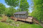 TWO FOR THE PRICE OF ONE! Escape the hustle and bustle of city life to enjoy nature at its finest. Situated on a private road within the Minisink Valley School District, this unique lakefront property offers 2 cozy cottages on one lot overlooking Lake Claire. Both homes are very well maintained with renovations done both inside and out. Both homes are equipped to for year-round use, but are legally classified as seasonal. Cottage 1 welcomes you in to a sunny enclosed porch with Andersen picture window overlooking the lake, recessed lighting, hardwood flooring and charming brick accents with knotty pine trim throughout. The main living area offers a walls of windows bringing in endless amounts of natural light, providing the perfect space to sip your coffee while you take in the views. This 1 bedroom home offers everything from newer appliances, windows and doors as well as roof/gutters just to name a few. Stepping outside you will find your own private patio area where a simple set of table and chairs can provide a cozy space for outdoor dining. Ascending to the next terrace, you will come upon cottage 2. A large wraparound deck, which completely encompasses the home, invites you to entertain and enjoy from every angle. Inside, you will be awestruck by this home&rsquo;s ability to blend rustic charm with true loft style studio living. With vaulted ceilings and rafter beam architecture this home feels plenty larger than you would expect! The charm of wide plank hardwood floors and stacked stone wall accents will have you feeling right at home in your very own woodland cottage. Outside on the 3rd terrace, find additional yard space with plenty of room for play. Take a saunter down to the lake where you can enjoy a picnic or small bonfire while taking in the serene atmosphere. This property has deeded lake rights and direct access to the lake, so the pleasure is all yours! Each home has its own electric meter and septic system. Additionally, both septic tanks were recently replaced with new 500 gallon tanks. This property is an excellent option for those with an extended family looking for a move-in ready weekend getaway or anyone thinking about the possibilities of creating additional streams of income. Just minutes (in either direction) to shopping, medical facilities, public transportation and everything else you may need. This one-of-a-kind property is a rare find, see it today!