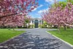 At the very end of a gated private cul-de-sac, behind a nearly quarter-mile of blooming cherry trees, lies a property that doesnâ€™t just promise peaceâ€”it delivers something far rarer: discovery. Welcome to 8 Tatem Way, a secluded 4.2-acre sanctuary offering panoramic views, tranquil birdsong, and the quiet rustle of deer passing through the neighboring Gandhi Peace Garden.This is not your typical Gold Coast estate. Rather than opulence for opulenceâ€™s sake, this home offers a rare connection to nature, backing directly onto SUNY Old Westburyâ€™s Gandhi Peace Gardens and the Old Westbury Village Equestrian Center. Thanks to a private easement, you have direct access to acres of untouched landâ€”perfect for nature lovers, equestrians, and those craving wide-open space and serenity.Imagine walking alongside Turkeys at sunrise, riding horses at sunset, and returning to the calm of country livingâ€”all just 22 miles from Midtown Manhattan. This isnâ€™t just a homeâ€”itâ€™s a lifestyle rooted in inspiration, tranquility, and possibility.Set on 4.2 manicured acres, the 7, 250 sq ft custom Colonial estate was built in 2007 by acclaimed builder Stewart Senter. It combines timeless luxury with modern comfort, all within the award-winning Jericho School District.Enter through grand 10-foot double doors into a dramatic two-story foyer, where radiant heated marble floors with an inlaid mosaic design meet a sweeping bridal staircase and gold-accented custom moldings. The gourmet chefâ€™s kitchen is a showstopper, featuring top-of-the-line Viking appliances, a walk-through pantry, and a full second summer kitchen for seamless entertaining.All six bedrooms are en-suites, including a primary suite that feels like a private retreat, complete with a sitting room, home office, expansive walk-in closet, and a spa-inspired bath with radiant heated floors.The fully finished walkout basement was built for unforgettable gatheringsâ€”with a home theater, dance floor, DJ booth, custom bar, and full bathroom.Outdoors, enjoy a full-size tennis court, expansive lawns, and wooded privacy. Thanks to the private equestrian easement, you can lead your horses straight from your property to nearby trails.Additional features include:Heated 3-car garageWhole-house generatorUnderground utilities and natural gasSeparate sewer system15-zone sprinkler systemFull Lutron lighting systemâ€”including illumination for the cherry treesThis extraordinary estate blends seclusion, elegance, and lifestyle, delivering the very best of North Shore living.