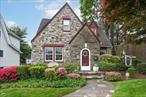 Nestled in the charming village of Williston Park, this inviting colonial boasts beautiful stone and brick exterior. This home blends classic character with comfortable living. Inside, you will find an extra-large living room with a cozy stone fireplace, the formal dining room flows beautifully for entertaining, while the eat in kitchen provides bright and functional space. Featuring four bedrooms and 2 full baths, the layout includes a first-floor bedroom or den. Upstairs you will find three generously sized bedrooms, each offering plenty of light and storage. Additionally, you have a one car detached garage and a serene backyard great for entertaining. Conveniently located, this home offers easy access to shopping, dining, and parks.