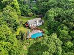 If privacy is important, you MUST SEE this property! Off the beaten path and at the end of a town maintained country lane, sits this contemporary home with stone front. PRIVATELY set on 1.57 acres, the property is located only 2.5 miles to downtown Yorktown Heights so you&rsquo;re close to shopping but set far away from the hustle and bustle. Modest 3 bedroom contemporary stone-front home features 1, 456sf upstairs and has more than 600sf of finished lower level space including a summer kitchen, full bathroom, family room and a bonus room - perfect for entertaining, guests or maybe even the in-laws. Hardwood floors just refinished. Vaulted ceilings and skylights showcase the entry and living space while allowing natural light to pour in. A wall of windows enhance the indoor/outdoor vibe. Spacious chef-inspired kitchen with stainless steel appliances, rich cabinetry and a large island with seating for four (or more). Beautiful, custom saltwater pool with a pretty waterfall, mature landscaping and huge stone patio complete the private backyard. Wonderful property set in a private location in the charming town of Yorktown Heights. Chicken, eggs, grow your own vegetables or an herb garden if you love the idea of homesteading. If you&rsquo;re looking for a buffer from the neighbors, you have that here too! The possibilities are endless! Discover the perfect blend of contemporary style and comfortable living, conveniently located near top rated schools, shopping, dining, recreation and transportation. Enjoy the beauty of living in the Hudson Valley and the proximity to fine dining (Peter Pratt&rsquo;s Inn is just 1/2 mile up the road). 24 hours notice required. SHOWN BY APPOINTMENT ONLY!