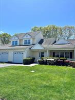 Welcome Home - This Beautiful and Lovely maintained 2 bedroom 2 1/2 bath home is located in the lively 55+ Community of Sunken Pond Estates. This Unit&rsquo;s features include One Car Garage with additional driveway space for a second vehicle, Spacious Covered Front Porch, Open Air Private Rear Patio. First floor includes Open Entry, Eat in Kitchen, Formal Dinning Room, Open Living Room with additional half bath and Vaulted Ceilings, Separate Laundry Room, Direct Garage Entrance and Primary Suite with en-suite bathroom and Walk In Closet,  Second floor includes Additional living, second Primary with en-suite and 2 closets. This Unit is in close proximity to the Community Clubhouse which includes Bocce Ball Court, Outdoor Pool, Gym, Bar, Library, Kitchen, Open Entertaining Space, Social Clubs and more. This Condo is conveniently located close to all - Shopping (Tanger 2.4 miles), Golf (Cherry Creek 2 miles), Wineries (2 miles and beyond), Pickleball (1.7 mile), Beaches LI Sound and South Shore Ocean Hamptons (1-15 miles) Medical/Hospital ( .04 mile).This home is a blank canvas looking for its next owner to put their finishing touches on it, new flooring throughout the entire house, come and see all the potential 1403 Pebble Beach Path has to offer! Appearance: Mint, Min Age:55 Pets Allowed/restrictions