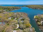 Located in one of Southoldâ€™s most coveted locations, this waterfront oasis offers peace, privacy, and stunning views of Goose Creek. Surrounded by professionally designed and meticulously maintained landscaping, this property exudes tranquility and natural beauty.The home features a spacious and thoughtfully designed layout with wood floors throughout. The updated kitchen is a chefâ€™s dreamâ€”complete with cherry cabinets, quartz countertops, high-end appliances, and limestone flooring. The large living room, anchored by a charming wood-burning fireplace, is perfect for relaxing or entertaining.Enjoy serene water views from multiple rooms and take full advantage of the private dock with floaterâ€”ideal for kayaking, boating, or simply soaking in the setting. A large waterfront patio provides plenty of room for entertaining. The primary suite includes an ensuite bath for added comfort. A full basement offers generous storage and expansion potential, and a whole-house generator ensures peace of mind. This rare Southold gem blends luxury, functionality, and waterfront livingâ€”ideal as a year-round residence or weekend escape.