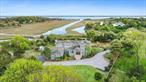 Nestled on +/-1.05 acres with access to Tanners Neck Creek and bordering a nature reserve, this 5-bedroom, 3.5-bathroom Hamptons home offers both privacy and breathtaking water views of Moriches Bay and Dune Road beyond. Built in 2001, the +/- 3, 659 sf home features a living room with a coffered ceiling and oversized windows and a recently renovated chef&rsquo;s kitchen complete with custom cabinetry, gorgeous countertops, and top-of-the-line appliances. The separate dining area overlooks the natural and serene setting from two picture windows with slider access to the expansive deck. An attached two-car garage, mudroom/laundry room, and updated powder room are conveniently located adjacent to the kitchen and dining area. A cozy den/sitting area, two guest bedrooms, and a full bathroom complete the first floor. Upstairs, a gracious primary suite with high ceilings offers a private retreat for relaxation. Enjoy sunrise and sunset from the private deck while taking in the sights and sounds of the natural beauty surrounding the property. Two additional guest bedrooms, a full bathroom, and an additional loft area complete the second floor. The house is equipped with a solar hot water heater allowing for a more energy efficient home. The beautifully landscaped grounds are complimented with a charming gardeners cottage for easy storage. With close proximity to the Village of Westhampton Beach, this property offers an unparalleled blend of luxury, comfort, and convenience to restaurants, boutique shopping, the Performing Arts Center, weekend farmers&rsquo; market, and world-class ocean beaches.