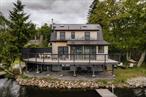 Glide into lake-life luxury. A wall of floor-to-ceiling glass frames sweeping, unobstructed views of pristine lake, pulling the shimmering water right into the living space. Step outside and youâ€™re on your own private dockâ€”drop a line at sunrise, tie up the motorboat for sunset cruises, or simply soak in the panorama from the sleek, cedar-trimmed deck. Completely rebuilt in 2025, this three-bedroom, two-bath home delivers a turnkey, modern retreat where every inchâ€”inside and outâ€”is brand-new.Inside, clean architectural lines and warm natural finishes create a breezy, gallery-like backdrop for effortless entertaining. The open living-dining area floats toward the lakefront glass, anchored by a cozy wood burning stove. A streamlined galley kitchen runs parallel to the view, outfitted with butcher block countertops and brass hardware, and an original built in corner pantry to preserve its original character. The three well lit bedrooms are upstairs, along with a bonus loft! Radiant-heat floors throughout downstairs, efficient central AC, and everything new top to bottom, the hard work is done, just arrive and play!Set in Lake Huntington nearby the best of Sullivan county&rsquo;s cafe&rsquo;s, breweries, and the music scene and Bethel Woods, while the NYS Thruway and Trailway&rsquo;s bus are nearby for an easy trip to NYC. Whether youâ€™re chasing summer weekends on the boat, four-season rental income, or a design-forward full-time escape, this flawless lakefront delivers the dreamâ€”just turn the key and dive in.