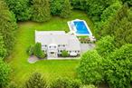 Exceptional Center Hall Colonial in the Heart of Montebello, NY! Located on a peaceful cul-de-sac, this stunning colonial invites you to experience a refined 4/5 bedroom, 2 full bath, 2 half bathroom home. Set on 1.33 acres of level, beautifully manicured property with stunning in ground pool, backing up to Canterbury Ln in Montebello Pines. This 4000+sq ft residence offers timeless charm, thoughtful upgrades, and abundant space for everyday comfort and entertaining. Step through the front door into a gracious foyer where sunlight pours in, drawing your eye to beautiful gleaming hardwood floors that flow seamlessly throughout the main level. A sophisticated formal living room welcomes you with soaring arched windows that frame the room and fill the space with soft, ambient light. Across the hall, a elegant formal dining room is set for memorable gatherings, from holiday celebrations to intimate dinner parties. An expansive, open-concept family room and kitchen, perfect for relaxed daily living, offers a warm and inviting family room with a striking stone-accented gas fireplace with a set of sliding doors opens to the outdoor living space, where the lush backyard becomes your private oasis. The chef&rsquo;s kitchen features a large center island, updated stainless steel appliances, pantry, and recessed lighting. A cozy dinette area enjoys views of the backyard and offers another sliding door exit, easy access to the oversized Trex deck, ideal for al fresco dining or morning coffee. Step outside and you&rsquo;ll discover a true entertainerâ€™s dream. The expansive, level yard boasts a sparkling in-ground pool with diving board, a custom patio with built-in firepit, and plenty of open lawn for play or relaxationâ€”all surrounded by mature trees for ultimate privacy and natural beauty. A versatile guest bedroom or home office is conveniently located on the main floor, along with a laundry area and updated powder rm. Upstairs, you&rsquo;ll find four generously sized bedrooms and two updated full bathrooms, including a luxurious primary suite complete with walk-in closet and spa-like en-suite bath featuring a double vanity and a modern standing shower. The finished walk-out basement adds even more living space, including a large recreation room, an additional half bath, a cozy office nook, and ample storageâ€”perfect for a home gym, media lounge, or guest quarters. Additional features include a two-car garage, baseboard heat (3 Zones), central air conditioning (1 Zone), security system, and so much more. This move-in-ready home offers the perfect blend of comfort, elegance, and outdoor enjoyment in an unbeatable Montebello location. Donâ€™t miss the opportunity to make this exceptional property your forever home. Schedule your private tour today!