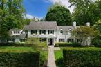 Tucked behind manicured hedges on a prized .47-acre parcel, this iconic Walter Uhl Colonial, completely rebuilt in 2003, offers a masterful blend of classic architecture and sophisticated modern living. Located in the prestigious enclave of Roslyn Estates, this 6-bedroom, 6 full and two half-bath residence is a rare and exceptional offeringâ€”where every bedroom features its own private en-suite bath, ensuring the ultimate in comfort and privacy. Sunlit and spacious formal living and dining rooms provide an elegant setting for entertaining, while the thoughtfully designed eat-in kitchen serves as the true centerpiece of the homeâ€”both refined and inviting. A custom built-in library offers an ideal space for a home office or quiet retreat. Upstairs, the private primary suite is set apart from four additional en-suite bedrooms, offering separation and serenity. Three staircases, main-level bedroom/bath, mudroom with laundry, and attached two-car garage add convenience and flexibility to this stately layout. The finished lower level offers endless possibilities for recreation, fitness, or media. Outside, the property boasts a bluestone patio, expanded driveway, and lush, level lawn, perfect for outdoor gatherings or quiet relaxation in total privacy. A slate roof, mature plantings, and timeless architectural detailing reflect the enduring quality and meticulous care of the home. Located within the highly-rated Roslyn School District and just minutes from the world-class shopping and dining, this is a rare opportunity to own a true estate-caliber property in one of the North Shoreâ€™s most coveted communities.