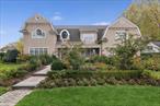 Nestled in the heart of Garden Cityâ€™s Central Section, this stunning Colonial, built in 2014, seamlessly blends classic elegance with modern luxury. Designed to create a bright and welcoming atmosphere, the home is filled with natural light. A dramatic front-to-back center hall, featuring 22-foot ceilings and custom wood-carved balusters, immediately captivates visitors. Ocular windows enhance the sense of grandeur and further illuminate the space.The home features walnut and oak flooring sourced from Seneca Hardwood, offering both beauty and historical significance. The family room boasts 12-foot ceilings with reclaimed antique barn wood beams, creating a warm, inviting atmosphere. A custom-designed fireplace, crafted in France from locally sourced reclaimed limestone, adds character and ties the room together. This space flows effortlessly into the Chefâ€™s â€˜Actionâ€™ kitchen, designed by celebrity chef David Burke. The kitchen is a masterpiece with imported Italian millwork, high-iron glass display shelves, and a striking blue-green Ann Sachs backsplash. It is fully equipped with top-tier appliances, including a Subzero Kitchen Pro glass-door refrigerator, beverage bar with an ice maker and wine storage, and Wolf cooking equipment featuring a 48â€ gas range with burners, charbroiler, griddle, induction burners, double wall ovens, warming drawer, and microwave drawer.The breakfast room, designed to bring the outdoors in, features wraparound windows and French doors leading to a patio with a fireplace, ideal for seamless indoor-outdoor living. The formal living room and family room, adorned with French doors and transom windows, also open to the outdoor spaces, creating a perfect flow for entertaining.A standout feature of the home is the powder room, which showcases hand-pressed tiles sourced through Ann Sachs, turning this functional space into an artistic focal point. The second floor is home to a luxurious primary suite with his-and-her dressing rooms, both with elegant millwork, and a spa-like bathroom. The bathroom includes a two-person walk-in shower, separate vanities, water closets, and a soaking tub. Additionally, four spacious bedrooms are serviced by two beautifully appointed full bathrooms and a convenient laundry room.The third-floor walk-up attic offers a bonus room and abundant storage space, while the basement recreation room is designed for entertaining, complete with a full bar and bathroom. The homeâ€™s outdoor spaces are equally impressive, featuring an English Garden landscape with lush greenery, walking paths, and over 60 varieties of roses and hydrangeas. The outdoor kitchen includes a professional Woodstone hearth oven and a dining area beneath a cherry canopy, perfect for al fresco dining. Multiple outdoor seating areas include one with a firepit and another with a fireplace, with ample room for a potential pool.Conveniently located near shopping, restaurants, and two LIRR train stations, the home offers easy access to both local amenities and commuting to the city. With its ideal combination of elegance, practicality, and luxurious features, this home is perfect for both relaxation and entertaining.